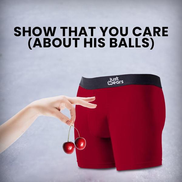 A clever, minimalist ad featuring a hand holding cherries next to a pair of red boxer briefs to communicate product comfort and support through visual humor.